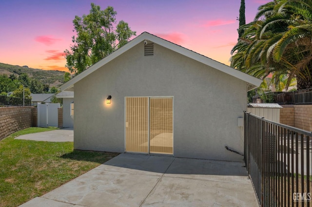 back of house with a patio area, a fenced backyard, and stucco siding