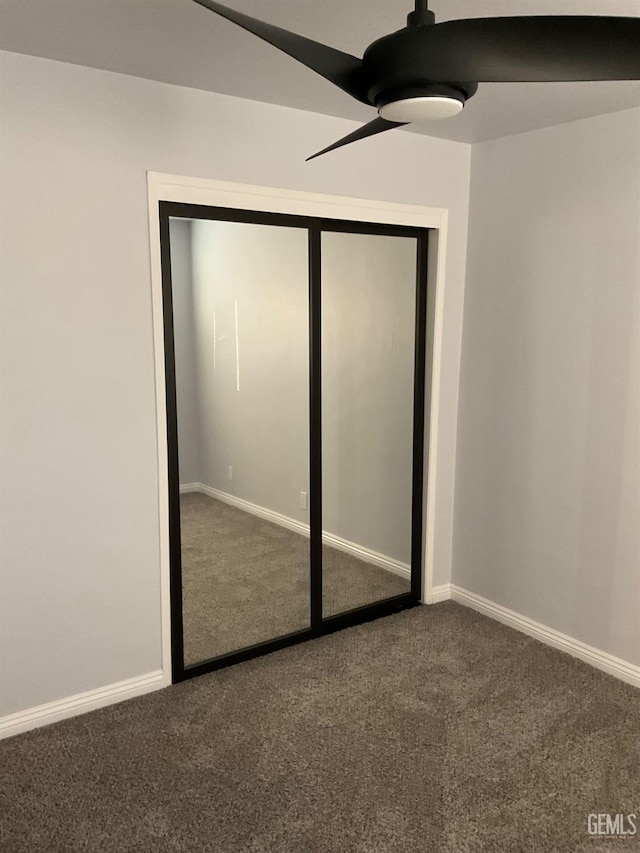 unfurnished bedroom with carpet, ceiling fan, and a closet