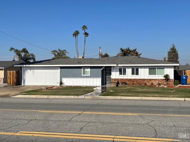 single story home with a garage and a front yard