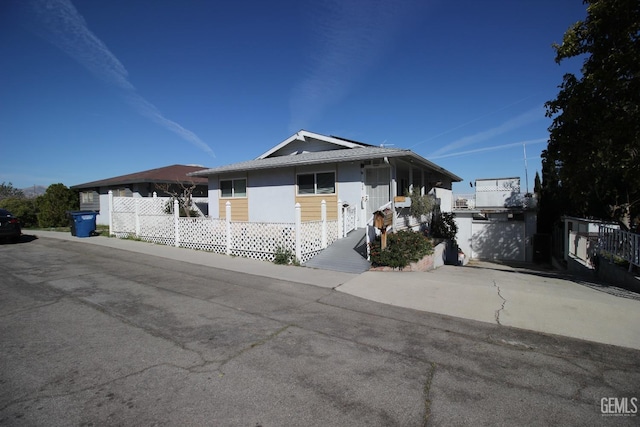 single story home featuring driveway and fence