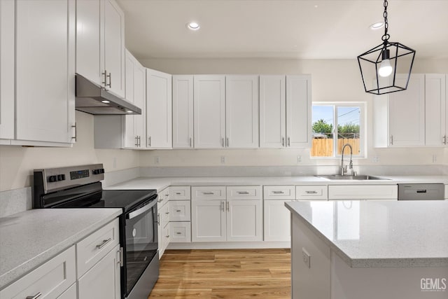 30717 Paseo De Pico, Shafter, CA 93263 - kitchen with stainless steel electric range oven, under cabinet range hood, white cabinetry, light wood-type flooring, and recessed lighting