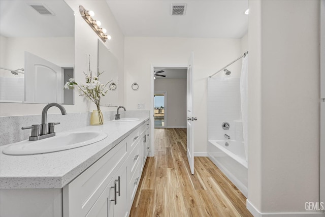 30717 Paseo De Pico, Shafter, CA 93263 - bathroom with wood finished floors, double vanity, washtub / shower combination, and a ceiling fan