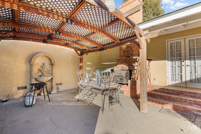 view of patio / terrace with french doors and a fireplace