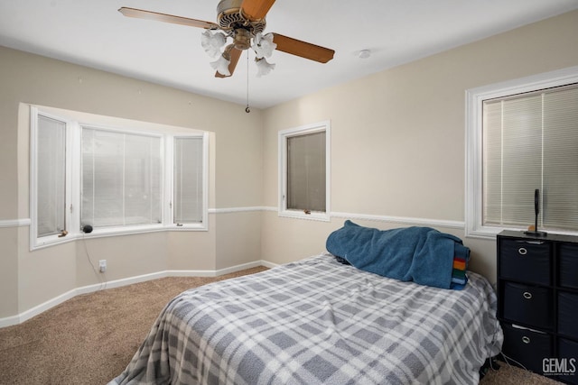 bedroom with ceiling fan and carpet floors