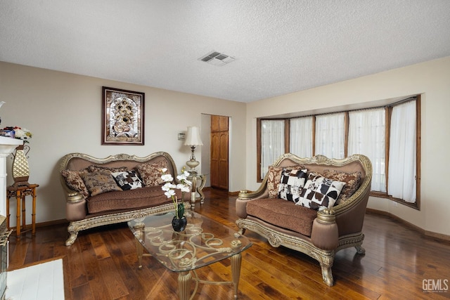 living room featuring a textured ceiling and dark wood-type flooring