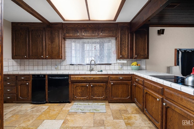 kitchen featuring sink, backsplash, tile countertops, and dark brown cabinetry