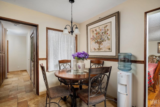 dining area with an inviting chandelier