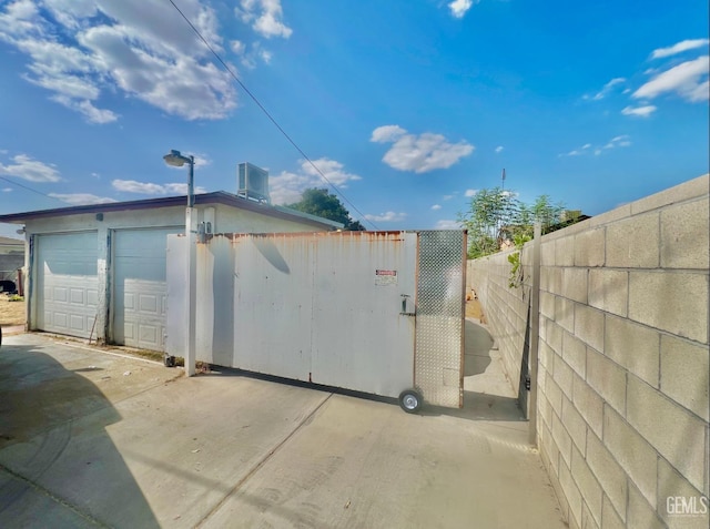 view of property exterior with central AC unit and a garage