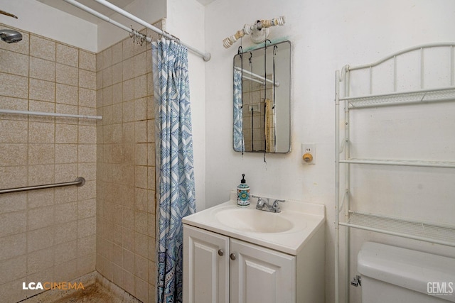 bathroom with walk in shower, vanity, and toilet