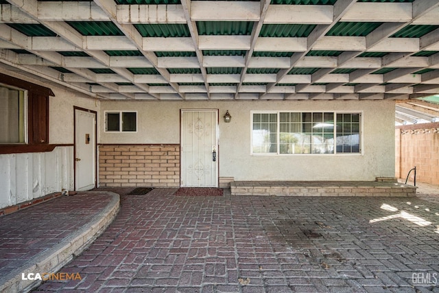 doorway to property with a patio area