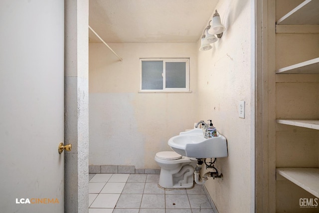 bathroom with tile patterned flooring, sink, and toilet