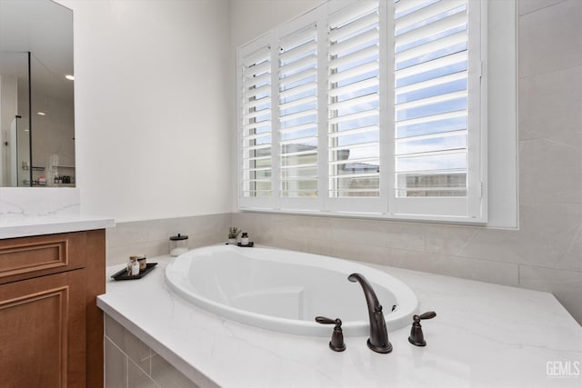 full bathroom with a bath and vanity