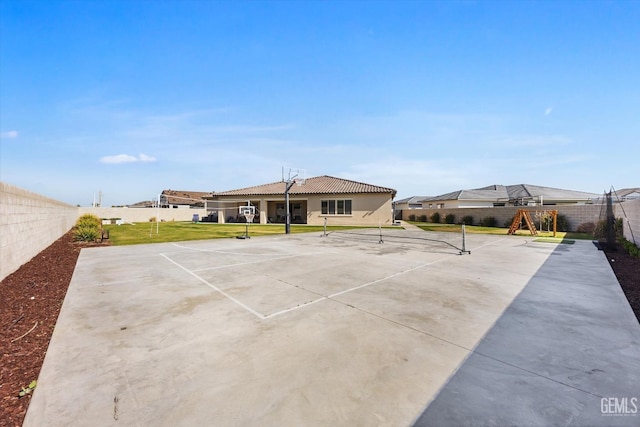 exterior space featuring a fenced backyard, playground community, and a lawn