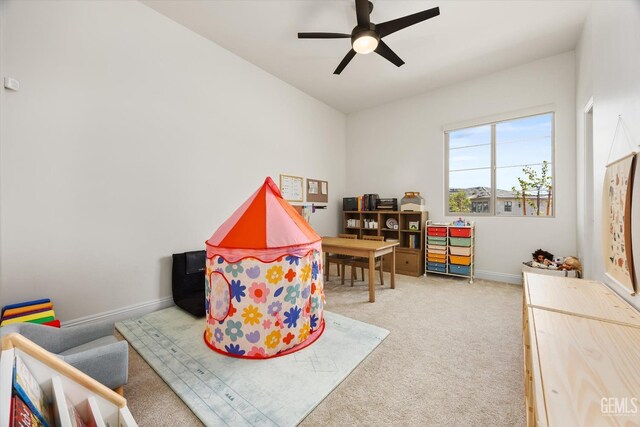 playroom with a ceiling fan, baseboards, and carpet