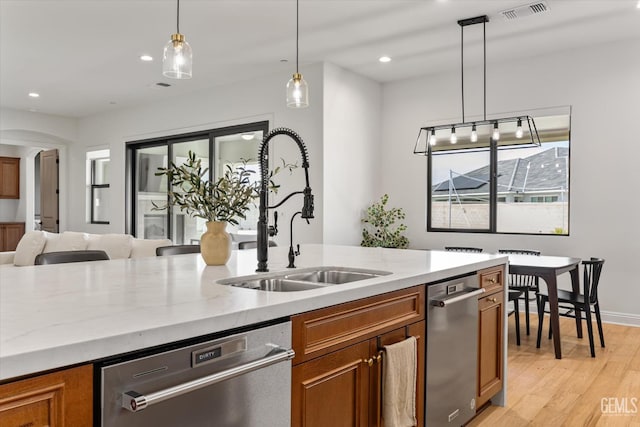 kitchen featuring a sink, visible vents, recessed lighting, brown cabinets, and dishwasher