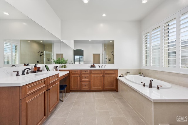 bathroom with plenty of natural light, tile patterned floors, a stall shower, and a sink