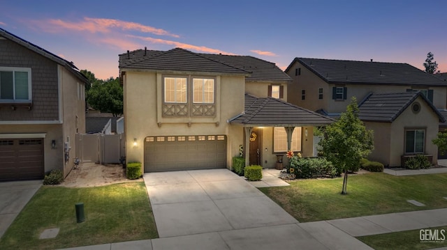 view of front of house featuring a lawn and a garage