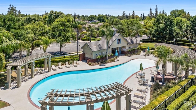 view of swimming pool featuring a pergola and a patio area