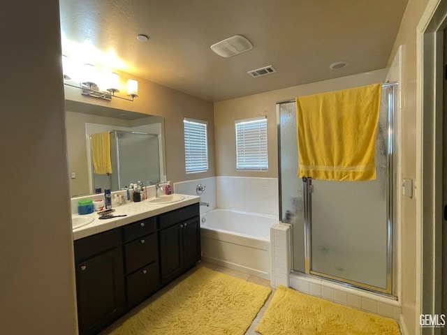 bathroom featuring tile patterned flooring, vanity, and plus walk in shower