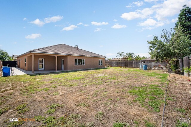 917 Newcastle Ct, Shafter, CA 93263 - back of house featuring stucco siding, a patio, and a tiled roof