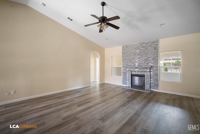 917 Newcastle Ct, Shafter, CA 93263 - unfurnished living room featuring a ceiling fan, a stone fireplace, wood finished floors, high vaulted ceiling, and arched walkways