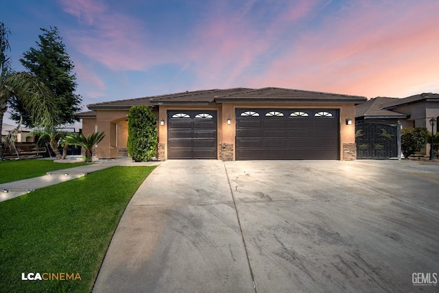 917 Newcastle Ct, Shafter, CA 93263 - ranch-style house featuring concrete driveway, an attached garage, stucco siding, and a lawn