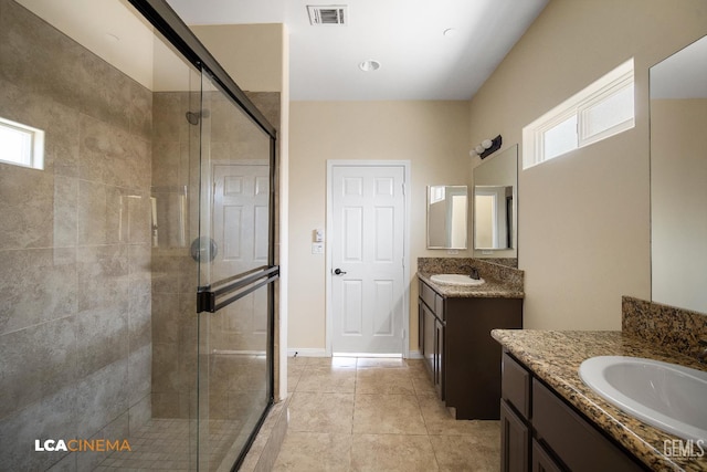 917 Newcastle Ct, Shafter, CA 93263 - full bath featuring a shower stall, healthy amount of natural light, two vanities, and tile patterned flooring
