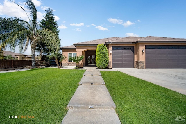 917 Newcastle Ct, Shafter, CA 93263 - view of front of house with stucco siding, french doors, an attached garage, driveway, and stone siding
