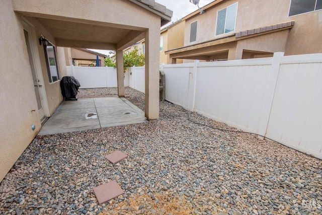 view of yard featuring a patio area and a fenced backyard