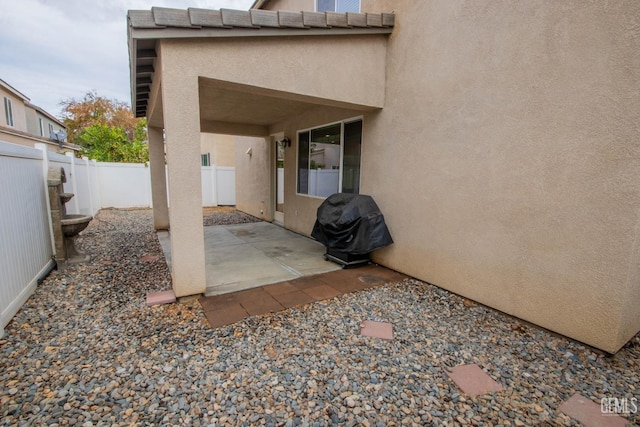 view of patio / terrace with a fenced backyard and a grill