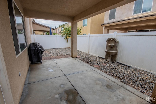 view of patio with a fenced backyard and area for grilling