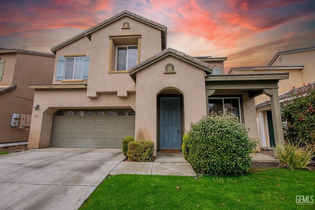 mediterranean / spanish house featuring a garage, concrete driveway, a tiled roof, and stucco siding