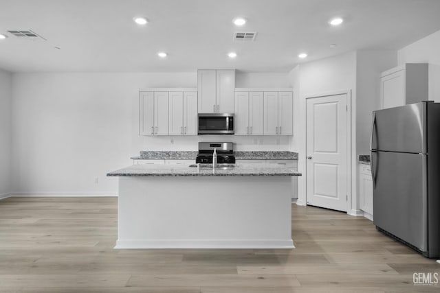 kitchen with appliances with stainless steel finishes, recessed lighting, visible vents, and a sink