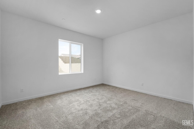 empty room with recessed lighting, carpet flooring, and baseboards