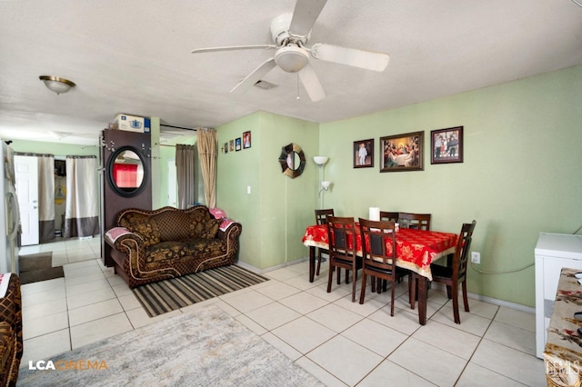 dining area with ceiling fan and light tile patterned floors