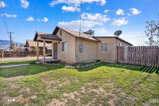 rear view of house with a lawn