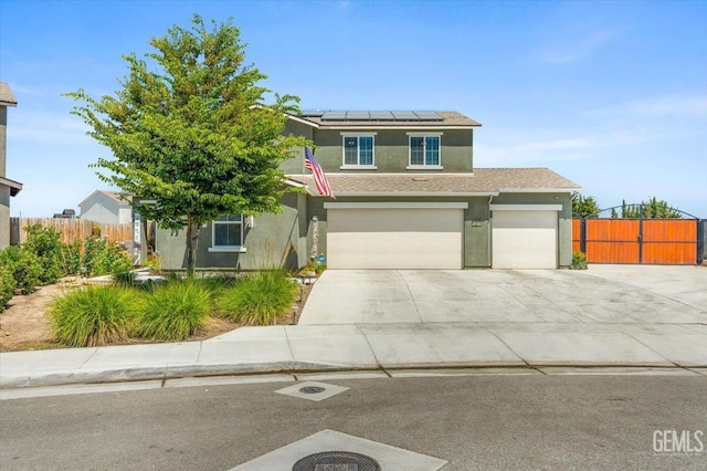 10026 Murfreesboro Dr, Bakersfield, CA 93311 - view of front facade with stucco siding, roof mounted solar panels, driveway, and a garage