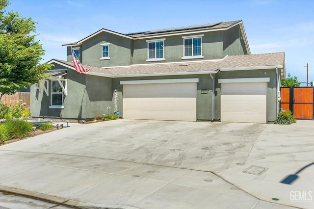 10026 Murfreesboro Dr, Bakersfield, CA 93311 - traditional home featuring stucco siding, solar panels, driveway, and a garage