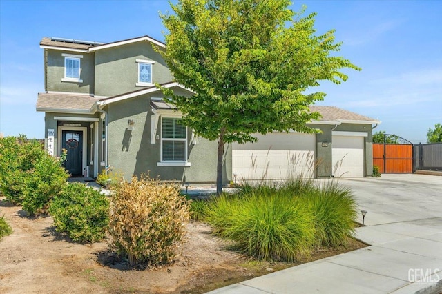 10026 Murfreesboro Dr, Bakersfield, CA 93311 - view of front of house with stucco siding, concrete driveway, solar panels, a garage, and a gate