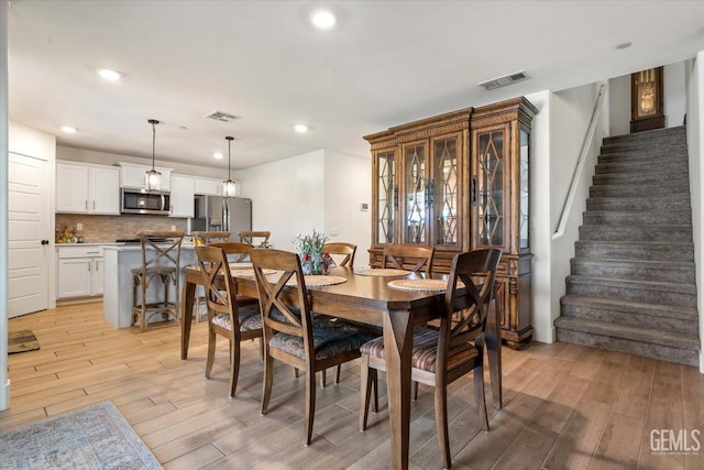 10026 Murfreesboro Dr, Bakersfield, CA 93311 - dining room featuring light wood-type flooring, stairway, and recessed lighting