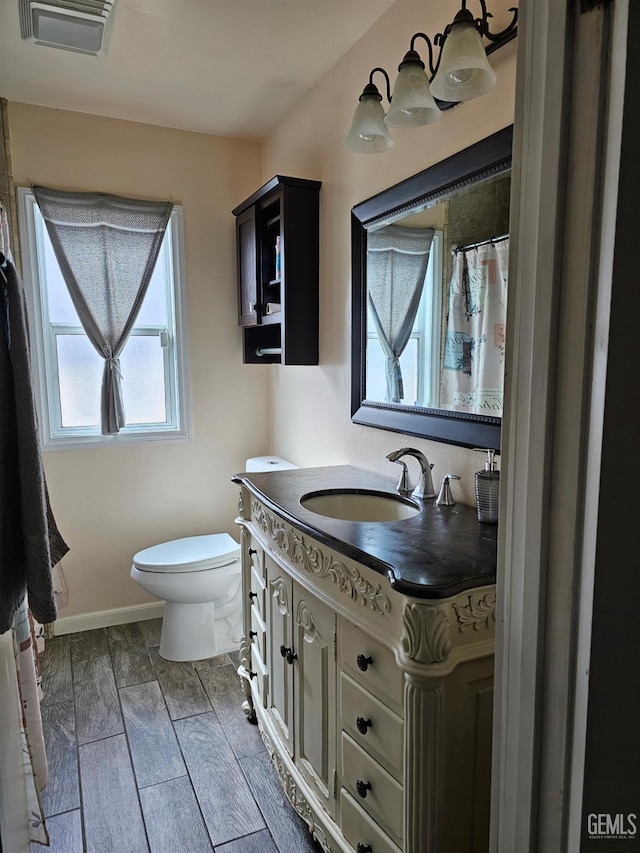 bathroom featuring vanity and toilet