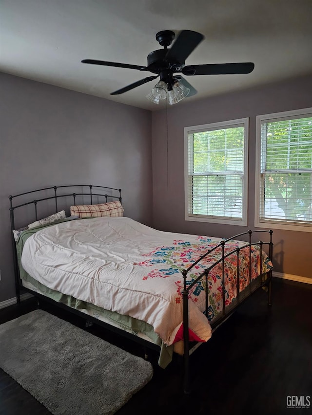 bedroom featuring ceiling fan and dark hardwood / wood-style flooring