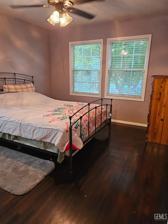 bedroom with dark hardwood / wood-style floors and ceiling fan