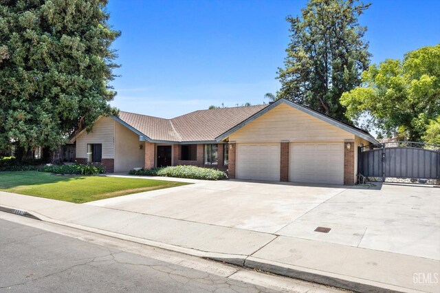 6801 Weldon Ave, Bakersfield, CA 93308 - single story home featuring brick siding, a garage, a front lawn, concrete driveway, and a gate