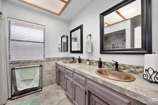 6801 Weldon Ave, Bakersfield, CA 93308 - full bathroom with tile walls, double vanity, wainscoting, and tile patterned flooring