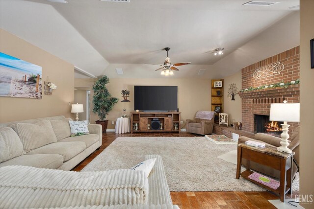 6801 Weldon Ave, Bakersfield, CA 93308 - living room featuring vaulted ceiling, wood finished floors, a fireplace, and ceiling fan