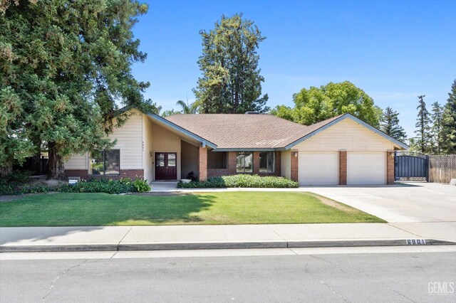 6801 Weldon Ave, Bakersfield, CA 93308 - view of front of house with an attached garage, brick siding, and concrete driveway