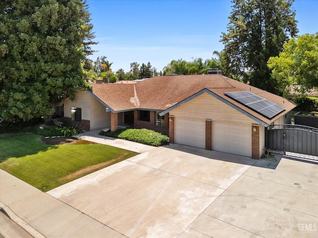 6801 Weldon Ave, Bakersfield, CA 93308 - single story home with brick siding, driveway, a gate, and a front lawn