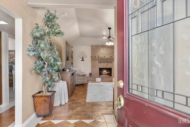 6801 Weldon Ave, Bakersfield, CA 93308 - foyer entrance with a ceiling fan, a fireplace, vaulted ceiling, and baseboards