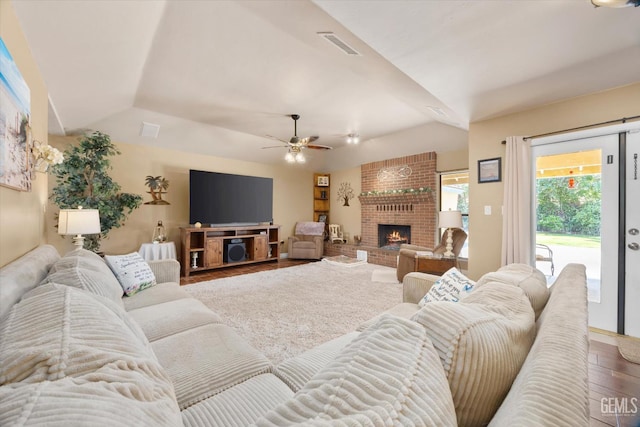6801 Weldon Ave, Bakersfield, CA 93308 - living room with wood finished floors, ceiling fan, a brick fireplace, and vaulted ceiling